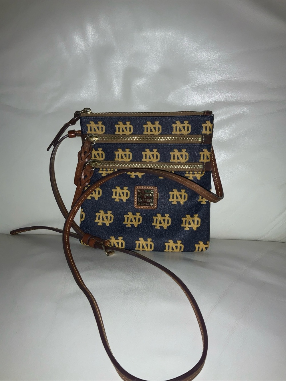 Dooney and Bourke Notre Dame Crossbody. Good condition, minor corner rubbing